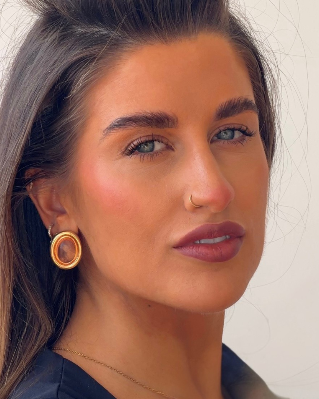 Dark haired girl, blue eyes, modelling for lash extensions