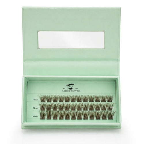 Set of false eyelashes in a green box with visible brand name.