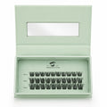 Set of false eyelashes in a green box with a clear lid on a white background